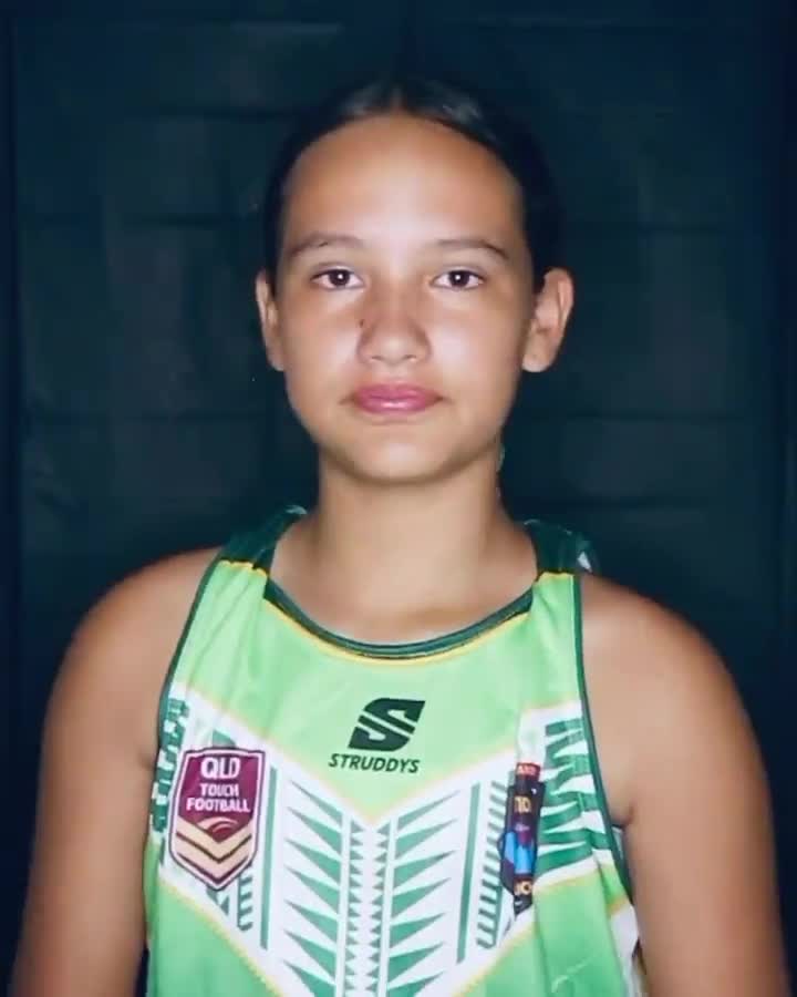 Girl in a green jersey wearing a ribbon